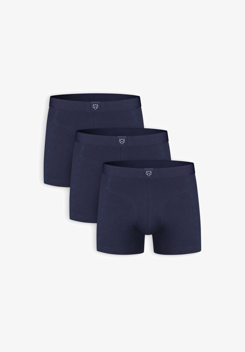 Navy blue boxer briefs made of soft fabric. Features a logo on the waistband, with contrasting stitch detailing. Three pairs shown.