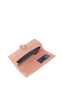 Pink leather wallet with a snap closure, multiple card slots, a zippered compartment, and a transparent ID window inside. Polka dot lining.