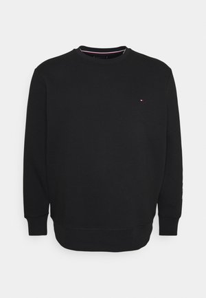 Czarna bluza z długimi rękawami, okrągłym dekoltem, ściągaczami przy rękawach i u dołu. Ma małe logo na klatce piersiowej i gładką fakturę.