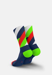 Multicolored socks featuring a geometric design with navy, bright green, red, and white stripes. Material appears smooth with contrasting toe and heel accents.