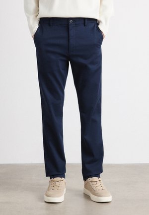 Navy blue trousers made of soft fabric, featuring a straight leg design, two side pockets, and a button closure at the waist.