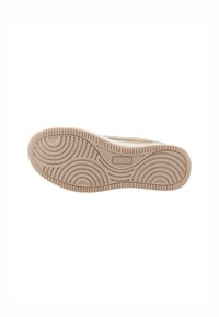 Semelle en caoutchouc beige avec un motif de vagues et de cercles, présentant une surface texturée et un détail de marque au centre.