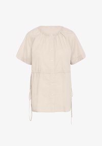 Camisa de manga corta con botones en algodón beige claro, con cuello fruncido, lazos ajustables en los laterales y un corte relajado.