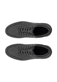 Black leather sneakers with a smooth finish, featuring contrasting white laces, minimalistic design, and rounded toe shape.
