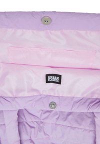 Light purple puffer jacket interior, smooth satin texture, featuring a square pocket and Urban Classics tag, secured with metal snap closure.