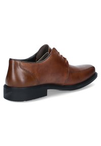 Bruine leren dresschoenen met een gladde afwerking, vetersluiting en een ronde neus. Beschikt over een zwarte rubberen zool en stiksels als accent.