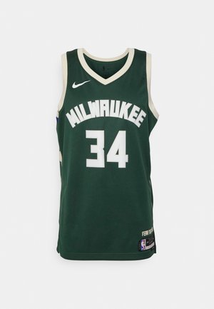 Zaļš basketbola krekls ar baltiem akcentiem, uz kura priekšpuses ir teksts "MILWAUKEE" un numurs "34". Parādīts Nike logo. Acs auduma faktūra.