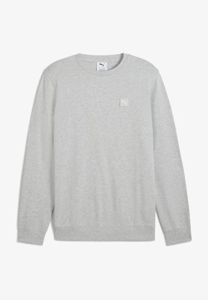 Lys grå sweatshirt med lange ærmer, ribbede manchetter og kant, samt et lille mærke med logo på venstre øverste bryst. Blødt stof tekstur.