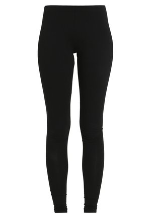 Leggings noirs en tissu extensible, avec une coupe ajustée et une taille sans couture, ornés de détails de fronces subtils au niveau des chevilles.