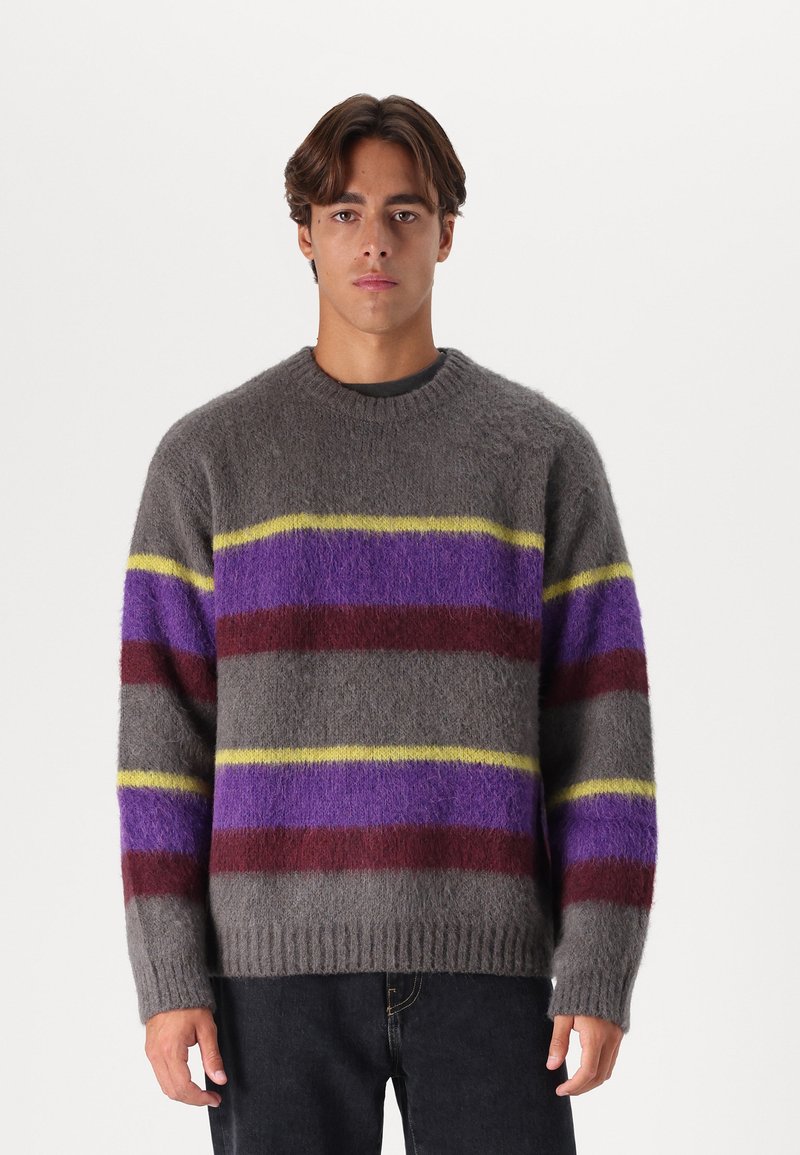 Szürke gyapjú pulóver vízszintes csíkokkal lila, piros és sárga színben. Kerek nyakkivágással és bordázott mandzsettákkal rendelkezik, puha tapintású.