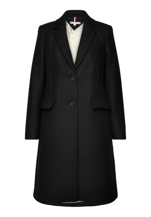 Cappotto nero in misto lana con un design su misura, chiusura con un solo bottone e rever a lancia. Presenta tasche laterali e uno spacco posteriore.