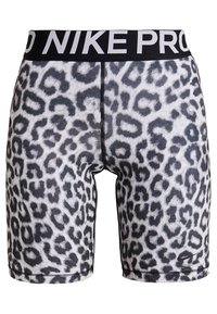 Nike Pro -housut leopardi-kuvioisena, mustalla vyötärölinjalla, jossa on valkoista tekstiä. Materiaali näyttää sileältä ja istuu tiukasti.