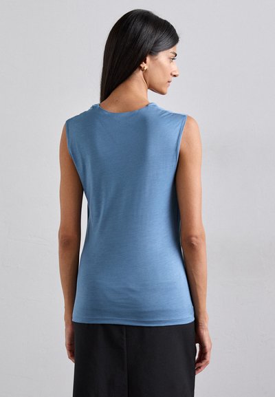 Ärmlös topp i ljusblått tyg med rund halsringning och passform som framhäver kroppen, med en slät textur och minimalistisk design.