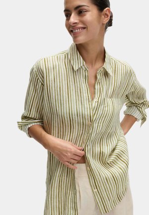 Chemise en lin rayée verte et blanche à manches longues, devant à boutons, col et poche poitrine. Tissu texturé et léger.