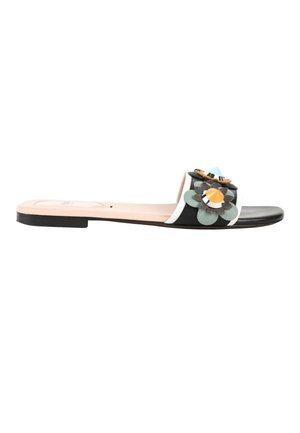 Sandale slide noire avec une semelle beige et des ornements décoratifs multicolores en forme de fleur sur la bride.