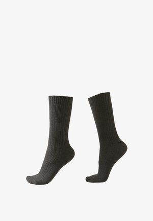 Chaussettes côtelées grises foncées avec un design haut jusqu'au genou, présentant un motif tricoté texturé et un renforcement au talon et aux orteils.