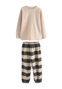 Lyse beige langærmet top i tekstureret stof kombineret med sort og beige ternede pyjamasbukser med elastisk taljebånd.