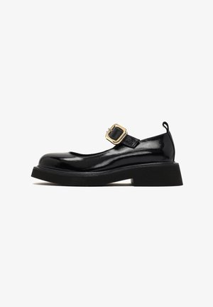 Black patent leather Mary Jane shoes with a low, chunky heel, rounded toe, and a thin adjustable strap featuring a gold buckle accent.