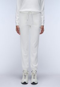 Witte sweatpants van zacht materiaal, met een elastische tailleband met trekkoord, geborduurde enkels en een subtiele merkdetail.