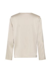 Chemise à manches longues beige vue de dos, avec un col rond simple et sans motifs ni ornements visibles.