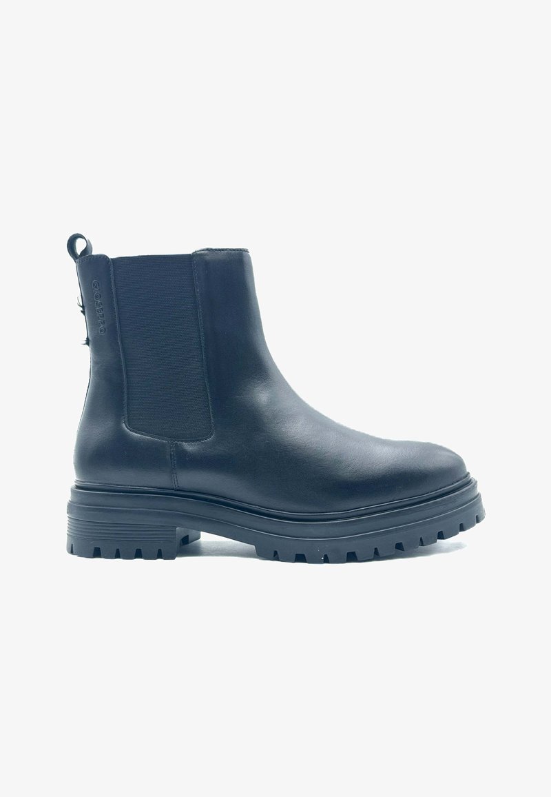 Botín de cuero negro hasta el tobillo con paneles elásticos en los laterales, punta redondeada, suela de goma gruesa y lengüeta en la parte trasera para facilitar el calzado.