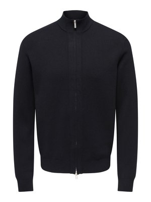Námořnicky modrý svetr na zip s vysokým límcem, pletená látka, dlouhé rukávy a hladká textura; na přední straně stříbrný zip a žebrované manžety.