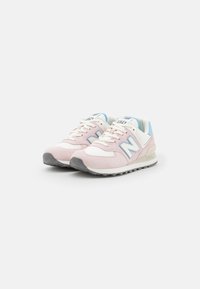 Pink and white sneakers with suede and mesh material. Features a light blue accent, logo on the side, and a textured rubber sole.
