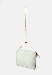Light green, soft-textured bag with a geometric pattern, featuring a braided hanging strap and colorful zipper pulls.