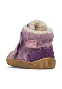 Lila Wildlederschuh mit einem flauschigen cremefarbenen Innenfutter, ausgestattet mit einem seitlichen Riemenverschluss und einem NATURTEX-Logo auf der Ferse. Genoppte Gummisohle.