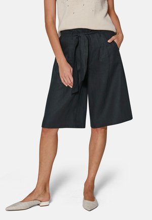 Dark linen culottes with a tie waist, featuring side pockets and a relaxed fit. Smooth texture and knee-length cut.