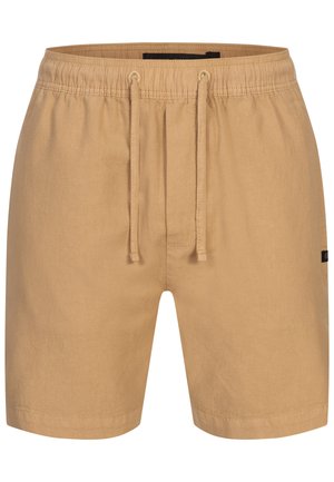 Tan shorts med elastisk talje, snøre detaljer og en glat tekstur. Har et lille sort mærke på siden.