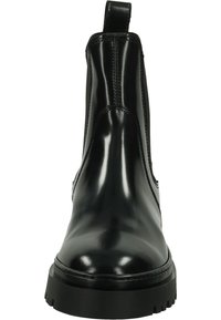 Black leather Chelsea boots with elastic side panels, a smooth glossy finish, and a chunky sole featuring deep treads for grip.