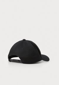 Black baseball cap with a curved brim, textured fabric, adjustable strap at the back, and a raised button detail on the top.