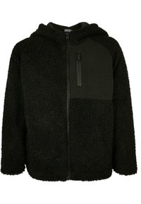 Zwarte fleece hoodie met een textuur, fuzzy buitenkant en een gladde, matte voorpaneel. Ritszak op de linker borst.