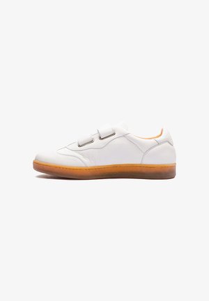 White leather sneaker with two Velcro straps, a rounded toe, and a light brown rubber sole. Features a textured upper and stitching detail.