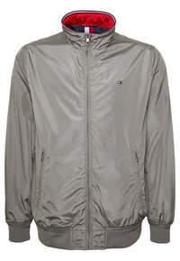 Gray zip-up jacket with high collar lined in red, elastic cuffs and hem, zip pockets, and small embroidered logo on chest.