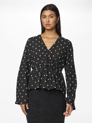 Black patterned blouse with white grid and dot design. Features a v-neck, long sleeves, and a gathered waist for a peplum effect.