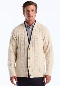 Ivoren kabelgebreide cardigan met een diepe V-hals, houten knopen en marineblauwe accenten. Gelaagd stof, lange mouwen en geribde manchetten.