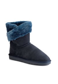Stivale alla caviglia in suede blu navy con risvolto in pelliccia blu soffice, punta arrotondata e suola in gomma testurizzata. Adatto per un look casual.