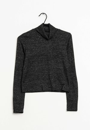 Schwarzer, verkürzter Rollkragenpullover mit langen Ärmeln. Hergestellt aus einem strukturierten Strickstoff, mit einer lockeren Passform und umgeschlagenem Kragen.