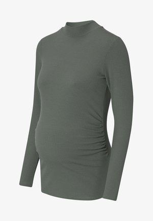 Long-sleeve, ribbed, olive-green maternity top with side ruching and a high neckline, designed to fit a pregnant silhouette.