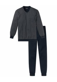 Jersey de cuello en V azul marino con patrón de cuadros en crema y mangas largas, combinado con pantalones de chándal azul marino a juego con puños elásticos.