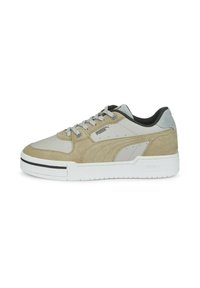 Light gray athletic shoe featuring a mix of smooth and suede materials, black accents, and a thick white sole with vertical ridges.