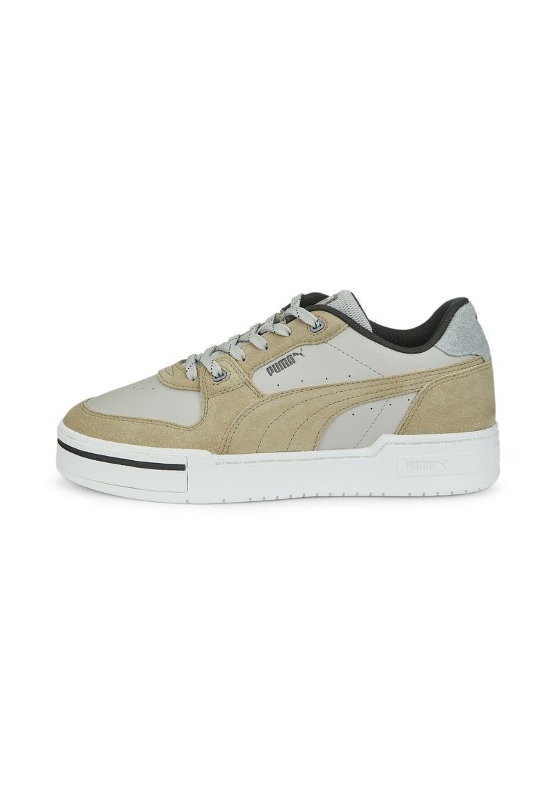 Light gray athletic shoe featuring a mix of smooth and suede materials, black accents, and a thick white sole with vertical ridges.