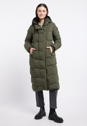 Long olive green puffer coat with a hood, featuring a quilted design, front pockets, and black accent details, paired with grey jeans and black boots.