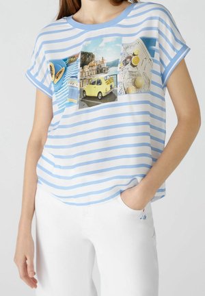 Striped blue and white short-sleeve top featuring graphic prints and a relaxed fit. Soft fabric with a round neckline and a dropped hem.