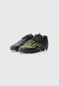 adidas Performance F50 CLUB UNISEX - Firm-ground football boots - core black/iron metal-coloured/lucid lemon