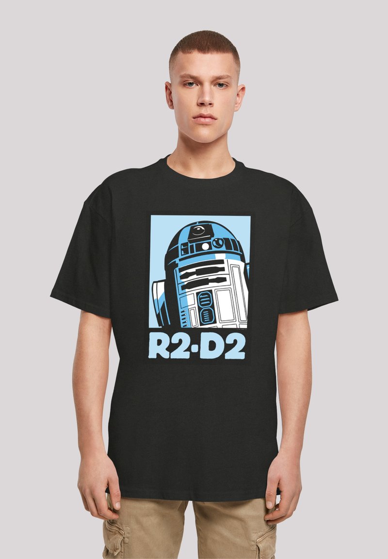 Svart bomull T-skjorte med et grafisk motiv av R2-D2 i blått og hvitt, med teksten "R2-D2" under designet. Korte ermer og løs passform.
