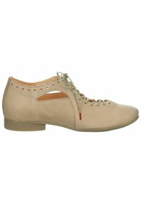Beige leather shoe with rounded toe, lace-up design, side cutouts, and subtle perforations. Flat sole with a slight heel and red accent.