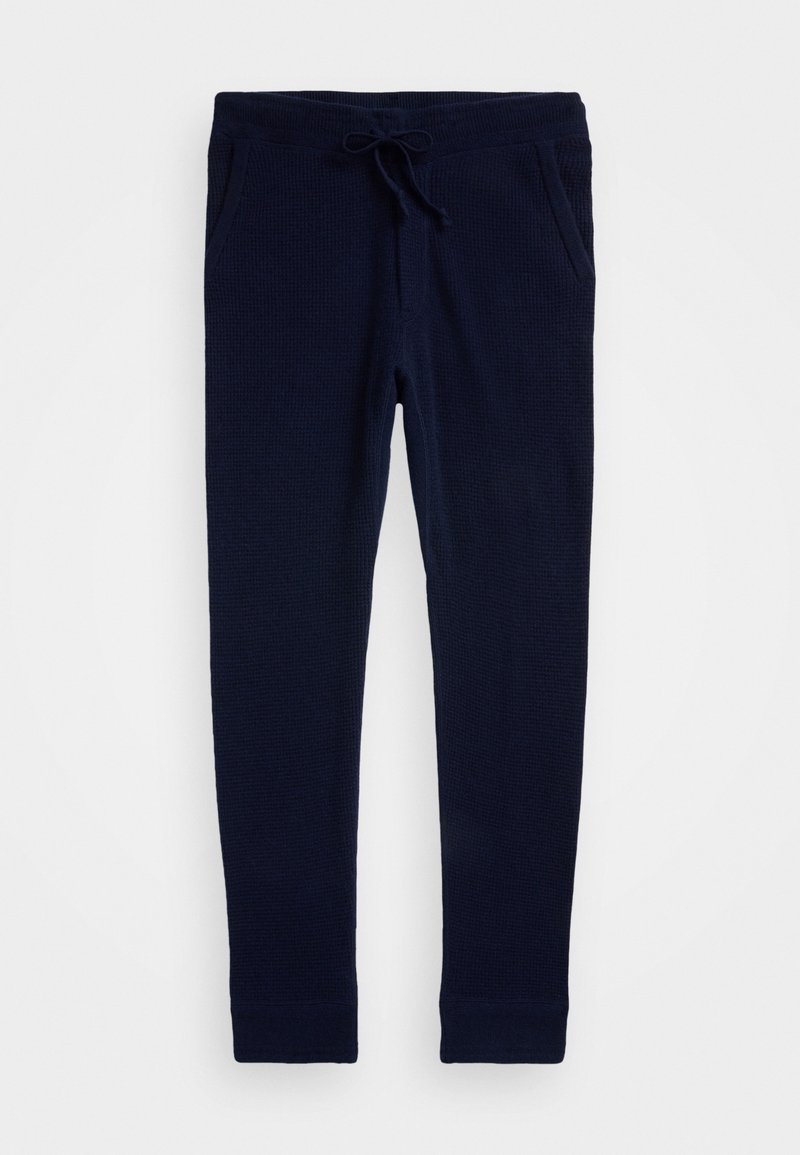Pantalones jogger de punto azul marino con cintura ajustable con cordón, bolsillos laterales y puños ajustados, mostrados extendidos sobre un fondo blanco.